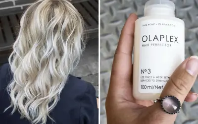 Vacker blont hår som stylats med vågor. En hand håller en flaska Olaplex No. 3, en hårbehandling för styrka.